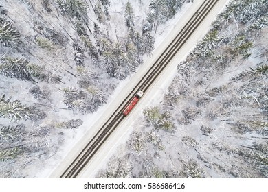 Aerial view of snow covered road in winter forest, truck passing by, motion blur - Powered by Shutterstock