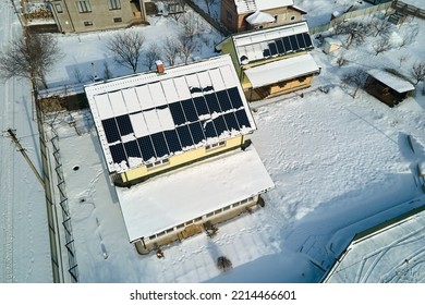 Aerial View Of Snow Melting From Covered Solar Photovoltaic Panels Installed On House Rooftop For Producing Clean Electrical Energy. Low Effectivity Of Renewable Electricity In Nothern Region Winter