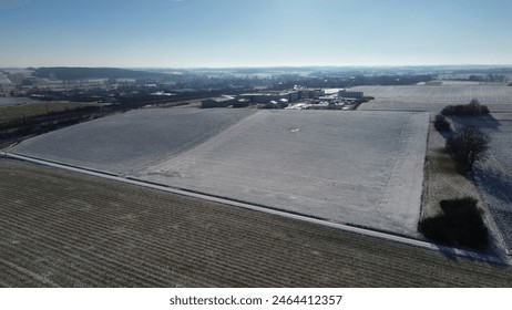 Aerial View of Snow-Covered Farmland in Winter Countryside - Powered by Shutterstock