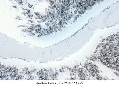 Aerial view of a snow-covered landscape with winding riverbanks, surrounded by frosty trees and softly undulating terrain. - Powered by Shutterstock