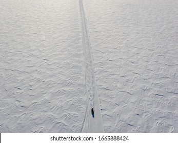 Aerial View Of A Snowmobile Crossing An Ocean Of Snow