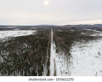 Aerial View Of Snowmobile Trail Through The Forest