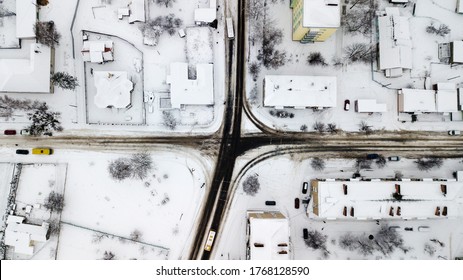 Aerial view of a snowy road in poor regions of Ukraine, in a village in winter.