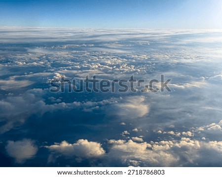 Aerial View of Soft Cloud Layers Above the Ocean