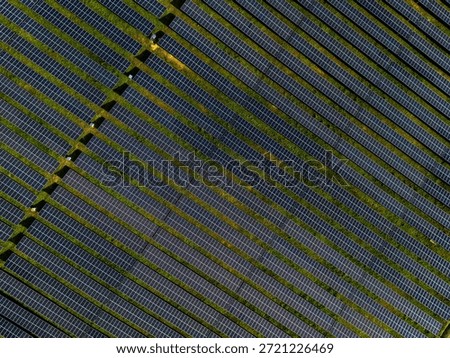 Aerial view of solar panel array at power station highlighting clean energy.