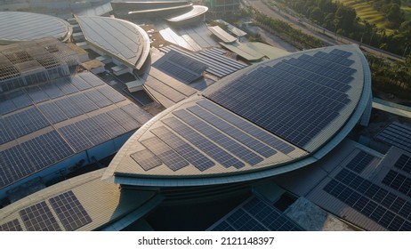 Aerial view of a solar panel photovoltaic with reflection on building roof top. Part of reduce reuse and restore, Renewable energy concept