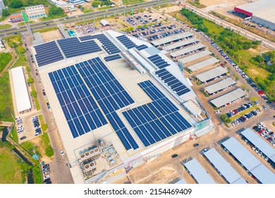 Aerial View Of Solar Panels Or Solar Cells On The Roof Of Shopping Mall Building Rooftop. Power Plant, Renewable Clean Energy Source. Eco Technology For Electric Power In Industry.