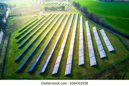 Aerial View Of Solar Panels On A Sunny Day. Power Farm Producing Clean Energy