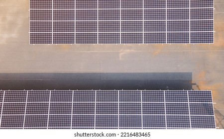 Aerial View Of Solar Panels On Top Of A Building, Eco Building, Or Factory. Solar Or Photovoltaic Cell On Panel On Top Of Roof. Direct Current Electricity Generation Technology, Based On Light