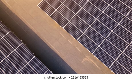 Aerial View Of Solar Panels On Top Of A Building, Eco Building, Or Factory. Solar Or Photovoltaic Cell On Panel On Top Of Roof. Direct Current Electricity Generation Technology