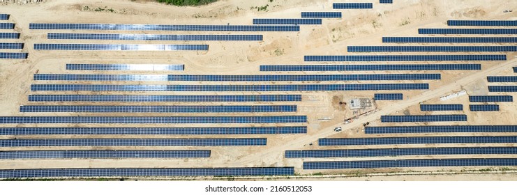 aerial view of solar panels under construction. power farm producing clean energy - Shutterstock ID 2160512053