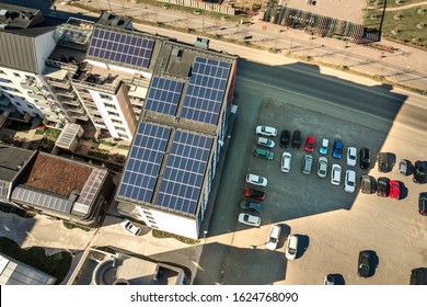 Aerial View Of Solar Photovoltaic Panels On A Roof Top Of Residential Building Block For Producing Clean Electric Energy. Autonomous Housing Concept.