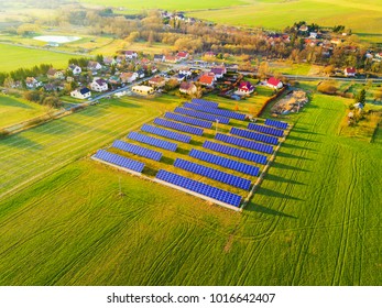 Aerial View Of Solar Power Plant. Photovoltaic Power Station Supplying Electricity To Small Town In Countryside. Renewable Solar Energy In The City.