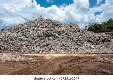 Aerial view of a solid waste processing facility surrounded by natural landscape. Concept of environmental management, urban waste control, and sustainable waste treatment.