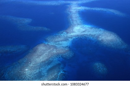 Aerial view of Somo Somo Strait and curving coral reef with brilliant blue sea, Taveuni, Fiji.