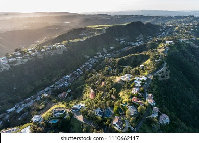 Aerial view of South Beverly Park hilltop homes in the Santa Monica Mountains above Beverly Hills and Los Angeles, California.  