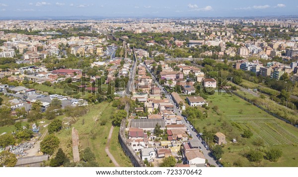Aerial view of the southern suburbs of Rome,\
capital of Italy. The cars run between the buildings and the\
streets of the suburbs of the\
city.