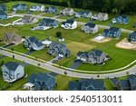 Aerial view of spacious new family houses in upstate New York suburban area. Real estate development in american suburbs