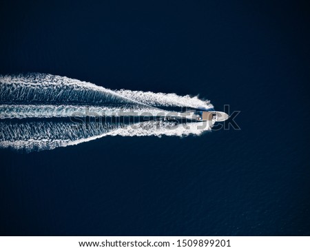 Aerial view of speed motor boat on open sea. Travel and leasure activities concept