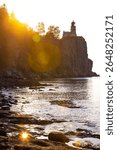 An aerial view of Split Rock Lighthouse at a scenic golden sunrise, highlighting the historic landmark and stunning coastal beauty