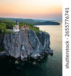 An aerial view of Split Rock Lighthouse at a scenic golden sunrise, highlighting the historic landmark and stunning coastal beauty