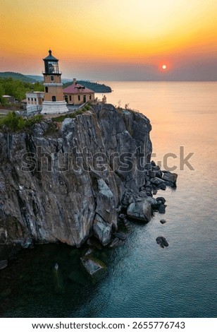 An aerial view of Split Rock Lighthouse at a scenic golden sunrise, highlighting the historic landmark and stunning coastal beauty