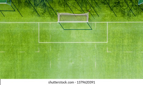 Aerial view of Sport concept of synthetic football or soccer field space with gates and grass background texture and empty space for copy