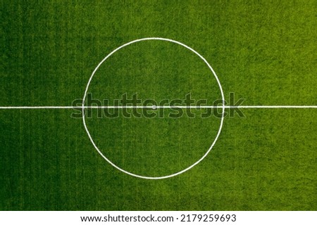 Aerial view of a Sports field in a residential area with artificial green grass and football goal in Santo Tirso, Portugal. Soccer pitch center top view background.