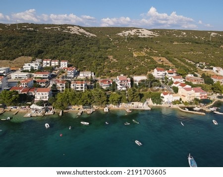 Aerial view of Stara Novalija in Island of Pag, archipelago of Croatia. Panoramic drone view of waterfront, idyllic and turquoise sea in town of Stara Novalja, Adriatic Sea in Dalmatia region.