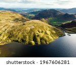 Aerial view of Stickle Tarn lake, located in the Lake District, Cumbria, UK. Popular tourist attractions in Great Langdale valley, famous for its glacial ribbon lakes and rugged mountains.