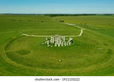 Aerial view of Stonehendge on a sunny day in summer with no people around. This is a historic site with a ring of standing stones, it was believed to be a burial site. Blue sky and space for text.