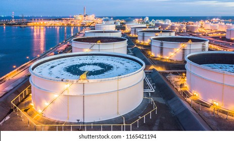 Aerial view storage tank farm at night, Tank farm storage chemical petroleum petrochemical refinery product at oil terminal, Business commercial trade fuel and energy transport by tanker vessel.