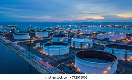 Aerial view storage tank farm at night  Tank farm storage chemical petroleum petrochemical refinery product at oil terminal  Business commercial trade fuel   energy transport by tanker vessel 