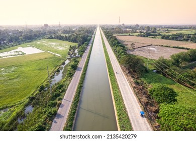 Aerial view of straight irrigation canal system management among the rice field and agronomic in countryside. Water management and environmental sustainability concept - Powered by Shutterstock