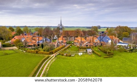 Aerial view of streets in hamlet of Niehove historical dwelling mound Village, Groningen Province, the Netherlands. Monumental scene in Europe.