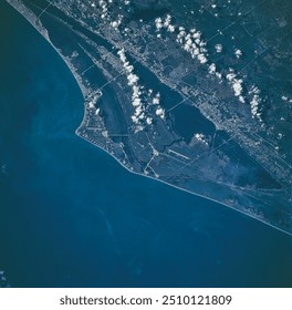 Aerial view of a stunning coastal landscape. Azure waters, sandy beaches, and a lush peninsula create a picturesque scene. Perfect for travel inspiration.. Elements of this image furnished by NASA - Powered by Shutterstock