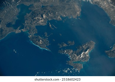 Aerial view of a stunning coastal landscape with turquoise waters, white sand beaches, and a dramatic mountain range in the distance. . Elements of this image furnished by NASA - Powered by Shutterstock