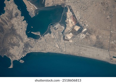 Aerial view of a stunning coastal landscape. Azure waters meet a sandy beach, with a peninsula jutting out into the ocean. The sky reflects in the water, . Elements of this image furnished by NASA - Powered by Shutterstock