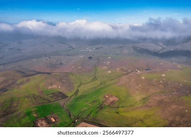 Aerial view of a stunning lake surrounded by rolling hills and natural landscapes in California. Perfect for nature enthusiasts, photographers, and travelers exploring the beauty of the great outdoors - Powered by Shutterstock