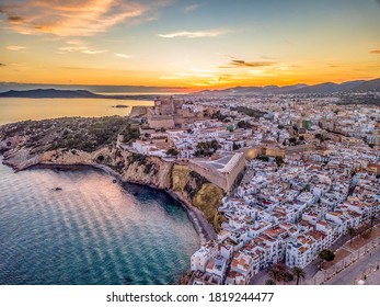 Aerial view of stunning sunset over Ibiza (Evissa) during a winter evening with view of the medieval fortress and the old town