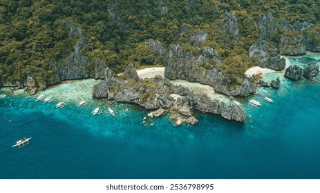 Aerial view of a stunning tropical island with turquoise waters and limestone cliffs in El Nido, Palawan, Philippines. - Powered by Shutterstock