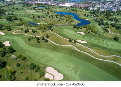 Aerial View Of A Suburban Golf Course Near A Residential Community.