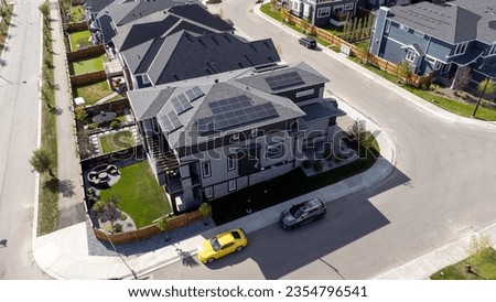 Aerial view of suburban homes in Calgary, Alberta with solar panels.