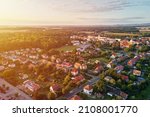 Aerial view of suburban neighborhood, Residential district with buildings and streets at small european town at sunset