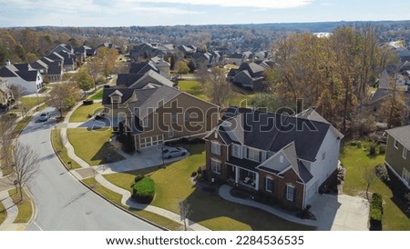Aerial view suburban residential street with row of upscale two-story new development houses and master planned community in distance background outside Atlanta, Georgia, USA. Large homes grassy lawn Foto stock © 