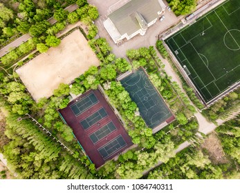 aerial view of summer sport camp courts and building in the forest