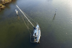 Aerial View Of Sunken Sailboat On Shallow Bay Waters After Hurricane In Manasota, Florida