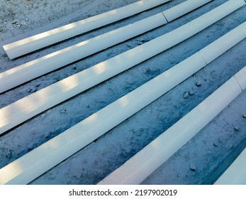 Aerial View Of Sunlit, Snowy Solar Panel Field, During Winter Sunset, In Scandinavia