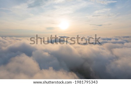 Aerial view of sunrise above fluffy sea fog misty clouds with mountain hill from Phu Tub Berk, Khao Kho, Phetchabun with sunlight. Abstract nature landscape background in morning.