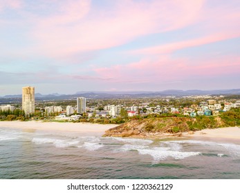 An aerial view of sunrise at North Burleigh and Miami headland on the Gold Coast